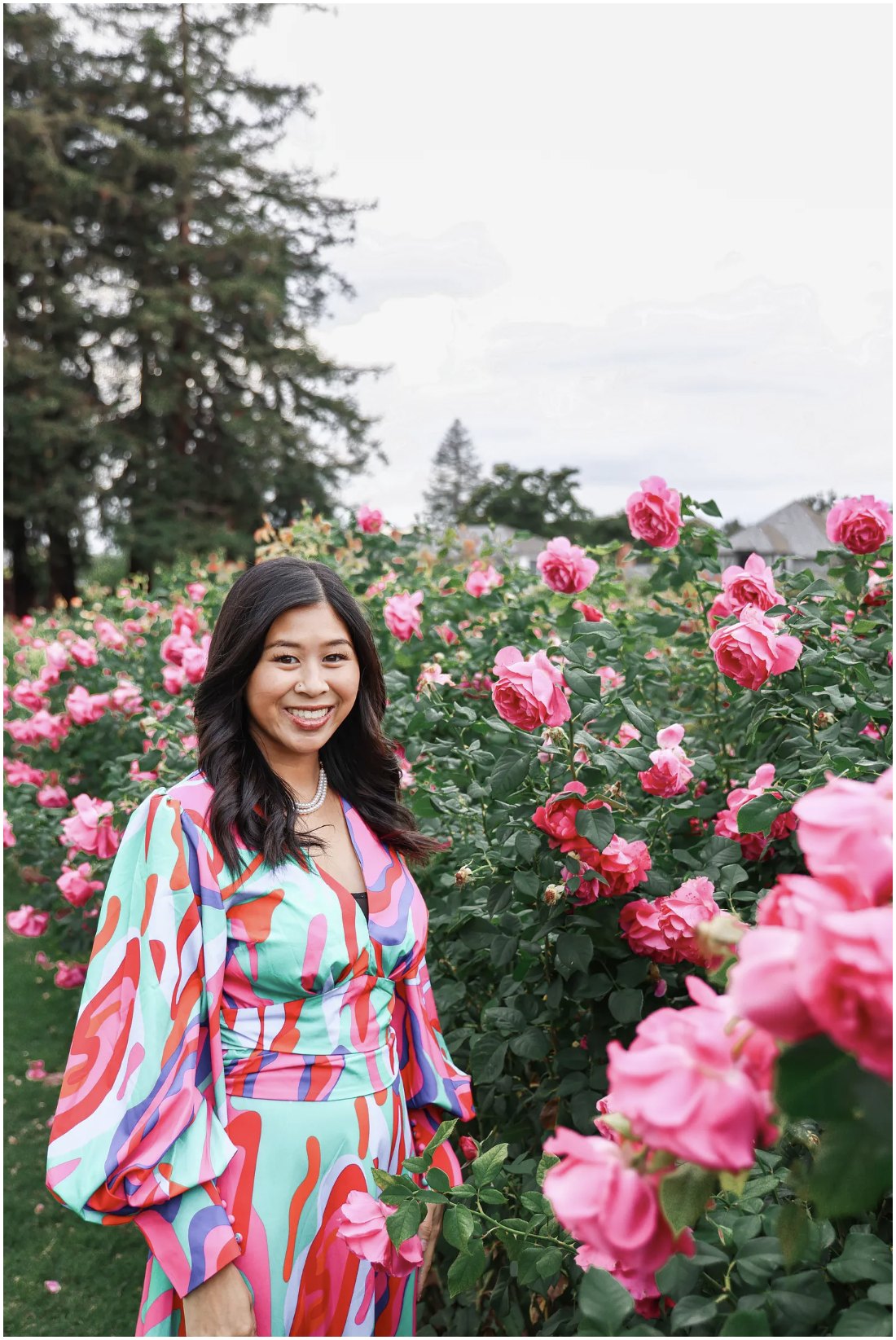 Bethany Philip smiling in a rose garden